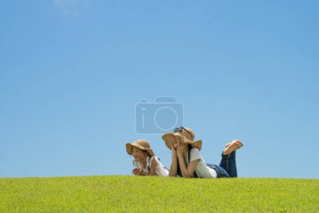 Photo for Mother and daughter relaxing on the lawn - Royalty Free Image