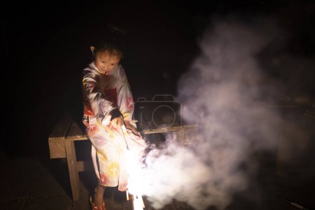 Photo for Girl playing with fireworks - Royalty Free Image
