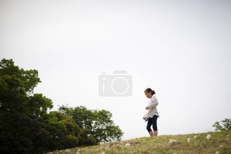 Photo for Girl standing in the meadow - Royalty Free Image