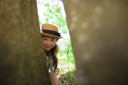 Photo for Little girl playing in the forest - Royalty Free Image