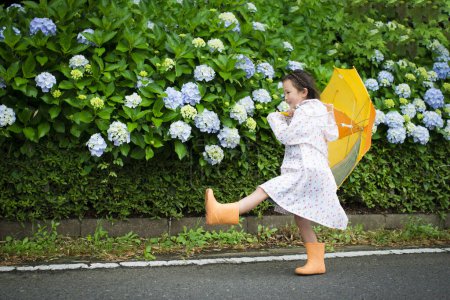 Photo for Hydrangea flowers and girl with umbrella - Royalty Free Image