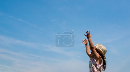 Photo for Girl playing with soap bubbles - Royalty Free Image