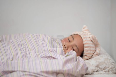 Photo for Asian little girl sleeping in bed - Royalty Free Image