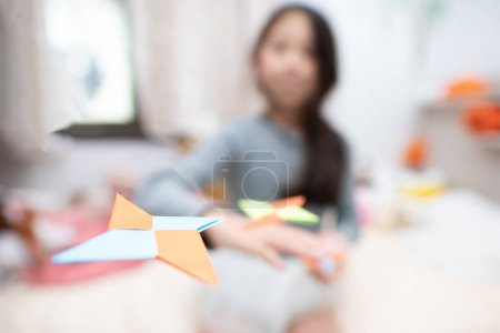 Photo for Child playing with origami shuriken - Royalty Free Image