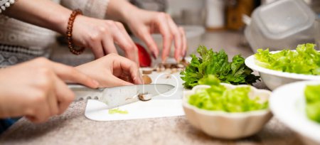 Photo for Mother and daughter making salad at home - Royalty Free Image