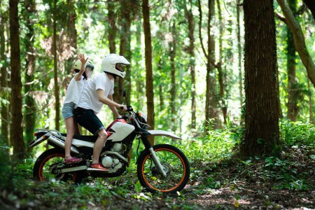 Photo for Father and daughter riding off-road bikes on mountain road - Royalty Free Image