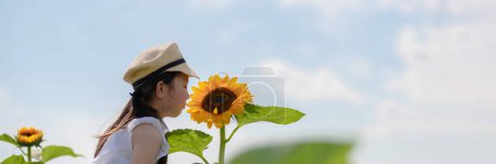 Photo for Girl playing in a sunflower field - Royalty Free Image