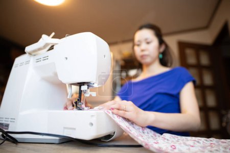 Photo for Woman using a sewing machine - Royalty Free Image