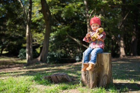 Photo for Girl sitting on the stump - Royalty Free Image