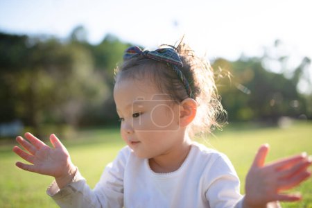 Téléchargez les photos : Petite fille jouant dans le parc - en image libre de droit
