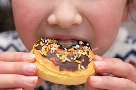 Photo for Girl eating a homemade donut - Royalty Free Image