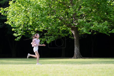 Photo for Girl playing in the grass - Royalty Free Image