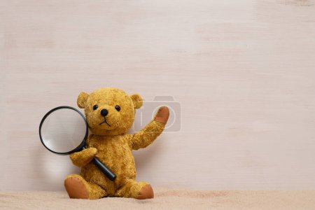 Photo for Teddy bear with magnifying glass - Royalty Free Image