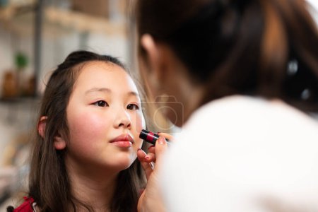 Photo for Daughter getting makeup done by mother - Royalty Free Image