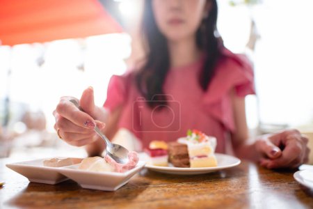 Photo for A woman who eats a lot of sweets - Royalty Free Image