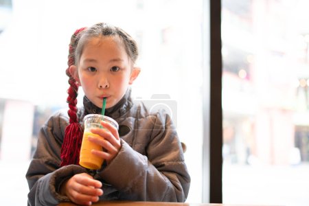Photo for Girl drinking juice in the shop - Royalty Free Image