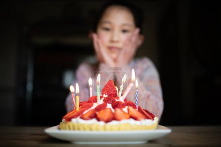Photo for Girl happy to see a birthday cake - Royalty Free Image