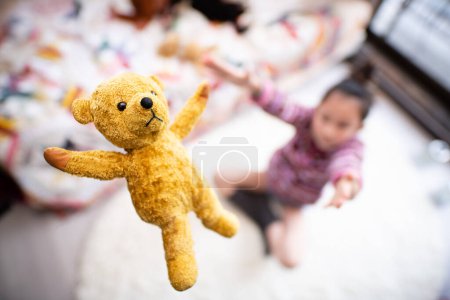 Photo for Girl playing with teddy bear - Royalty Free Image