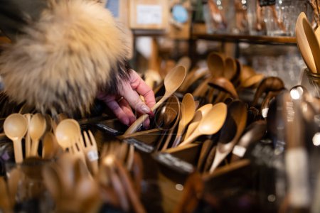 Photo for Woman's hand holding a wooden spoons - Royalty Free Image