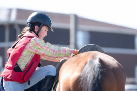 Photo for Girl learning to ride a horse - Royalty Free Image