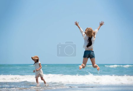 Photo for Mother and daughter having fun on the beach - Royalty Free Image