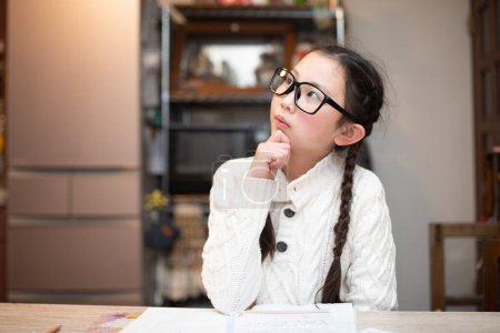 Photo for Girl wearing glasses worried while studying - Royalty Free Image