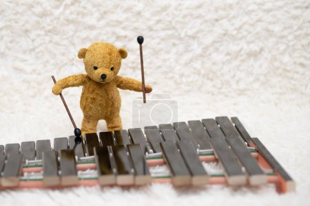 Photo for Teddy bear playing the xylophone - Royalty Free Image