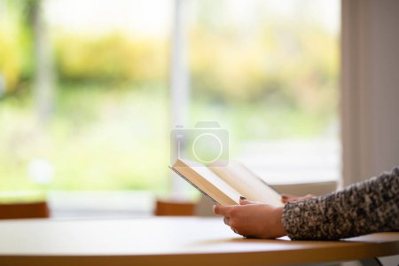 Photo for Hands of a woman reading a book - Royalty Free Image