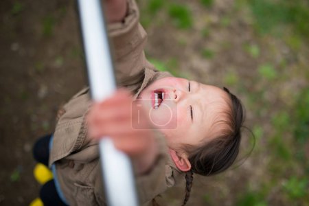 Photo for Girl playing in the horizontal bar - Royalty Free Image