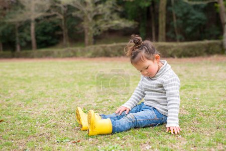 Photo for Girl sitting on the lawn - Royalty Free Image