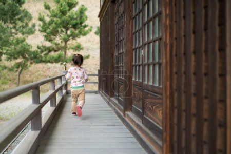 Photo for Cute  little asian girl  walking on terrace - Royalty Free Image