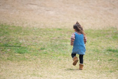 Photo for Girl running on a lawn - Royalty Free Image