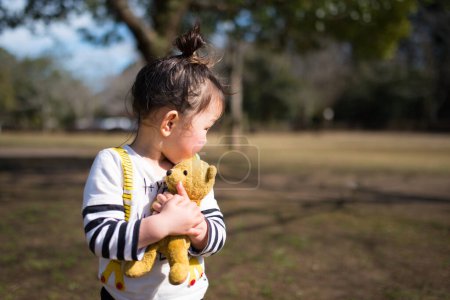 Photo for Little girl playing with a teddy bear - Royalty Free Image