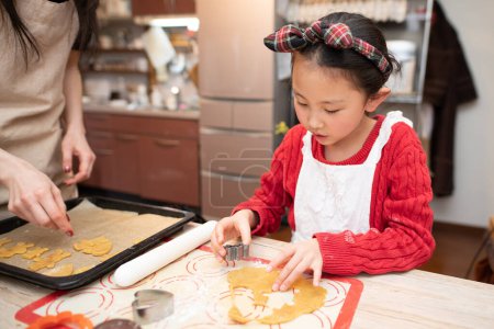 Photo for Mother and daughter making cookies - Royalty Free Image
