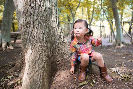Photo for Girl playing in the forest of the park - Royalty Free Image