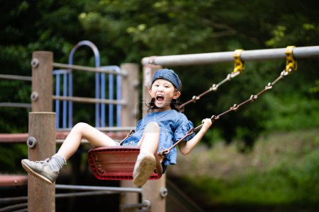 Photo for Girl playing on the swing - Royalty Free Image