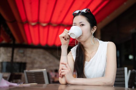 Woman drinking coffee in a cafe