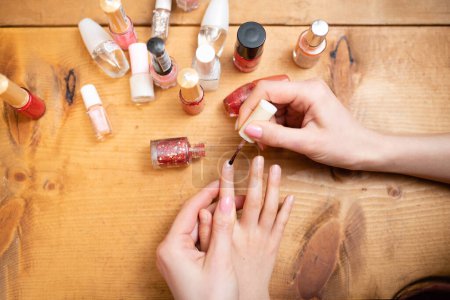 Photo for Mother's hand applying nail polish to her daughter's nails - Royalty Free Image