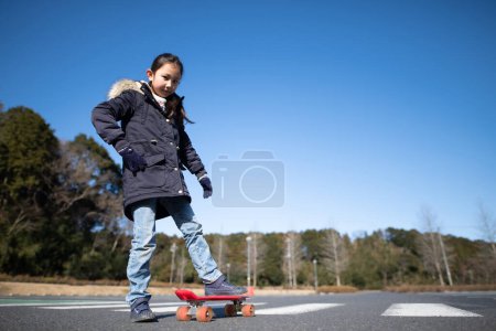 Girl playing on a skateboard
