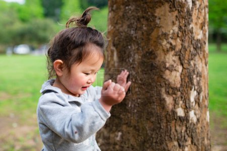 Photo for Big tree and toddler girl - Royalty Free Image