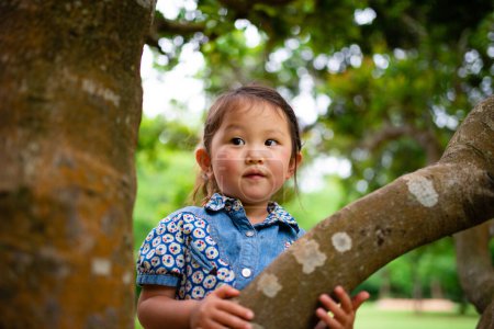 Photo for Little girl playing in the summer park - Royalty Free Image