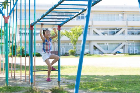 Photo for Girl playing with playset in the schoolyard - Royalty Free Image