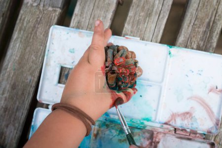 Téléchargez les photos : Couleur de peinture de l'enfant au cône de pin - en image libre de droit