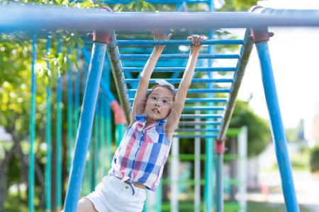 Photo for Girl playing with playset in the schoolyard - Royalty Free Image