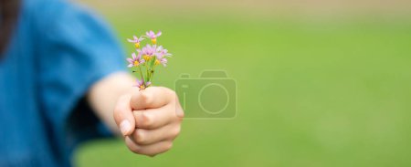 Photo for Child holding a small flowers - Royalty Free Image