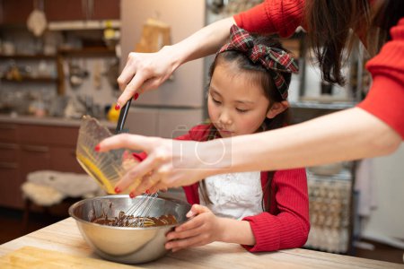 Photo for Mother and daughter making sweets - Royalty Free Image