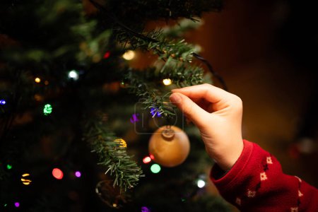 Photo for Children's hands decorating a Christmas tree - Royalty Free Image