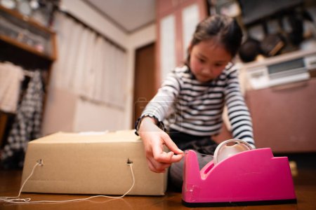Photo for A girl playing with cardboard - Royalty Free Image