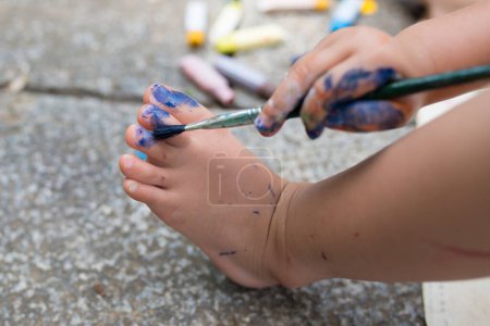 Photo for Child paint the color on foot - Royalty Free Image