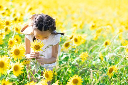 Photo for Girl playing in the sunflower field - Royalty Free Image